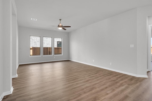 unfurnished room with dark hardwood / wood-style floors and ceiling fan