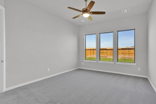 empty room featuring carpet flooring and ceiling fan