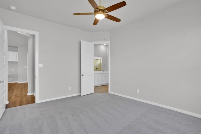 unfurnished bedroom with carpet flooring, connected bathroom, and ceiling fan