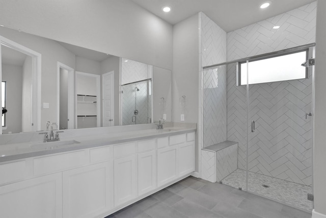 bathroom featuring vanity and an enclosed shower