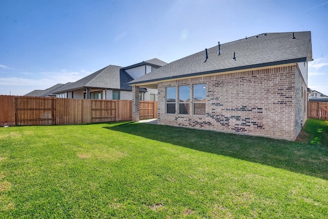 rear view of house with a lawn