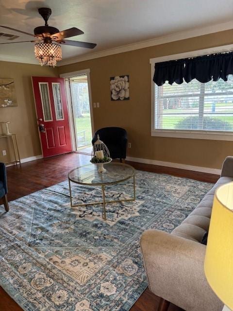 living room with ceiling fan, dark hardwood / wood-style flooring, and ornamental molding