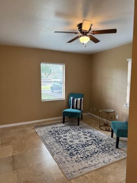 sitting room featuring ceiling fan