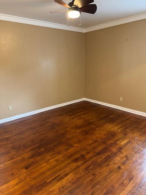 spare room with ceiling fan, dark wood-type flooring, and ornamental molding