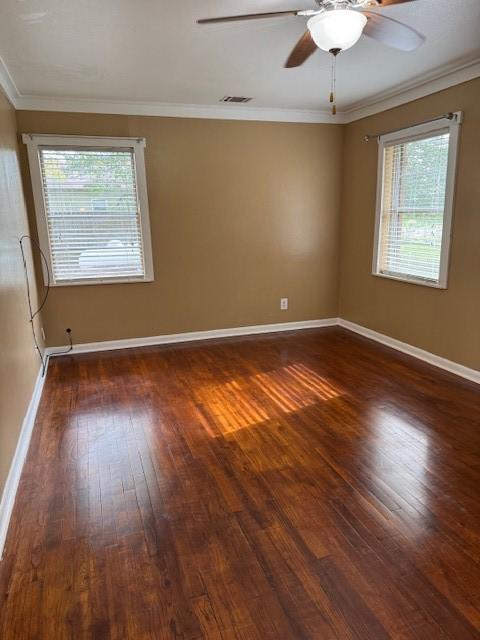 spare room with dark hardwood / wood-style floors, ceiling fan, and ornamental molding