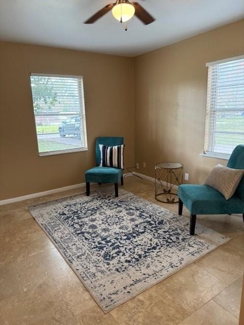 sitting room featuring ceiling fan and a healthy amount of sunlight