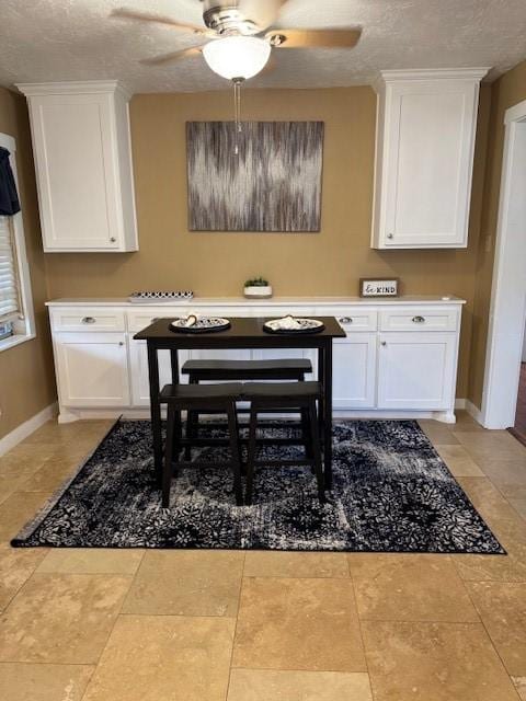 dining room featuring a textured ceiling and ceiling fan