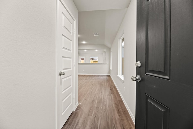 hall with light hardwood / wood-style floors