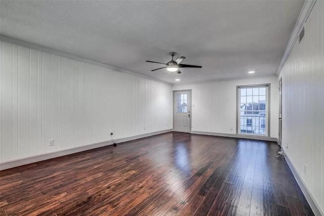 unfurnished room with crown molding, ceiling fan, and dark wood-type flooring