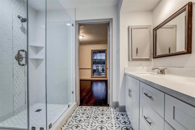 bathroom featuring tile patterned floors, vanity, and an enclosed shower