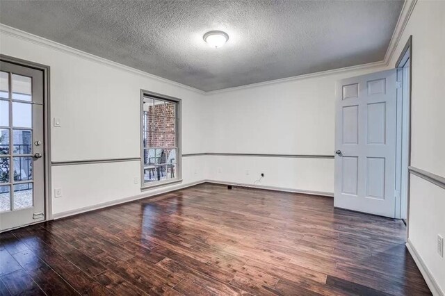 spare room with crown molding, dark hardwood / wood-style flooring, a healthy amount of sunlight, and a textured ceiling