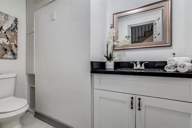 bathroom featuring vanity and toilet