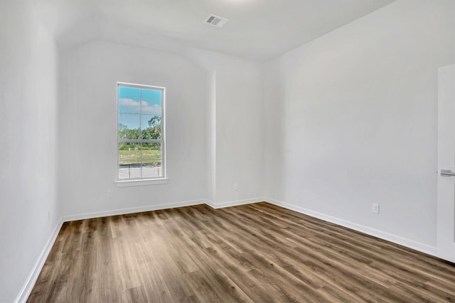 spare room featuring dark hardwood / wood-style flooring