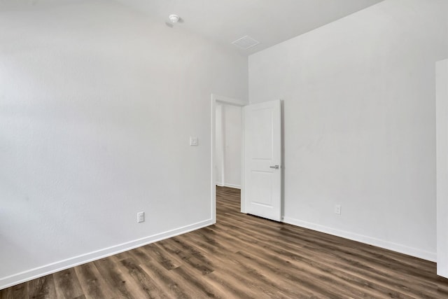 unfurnished room with dark hardwood / wood-style flooring