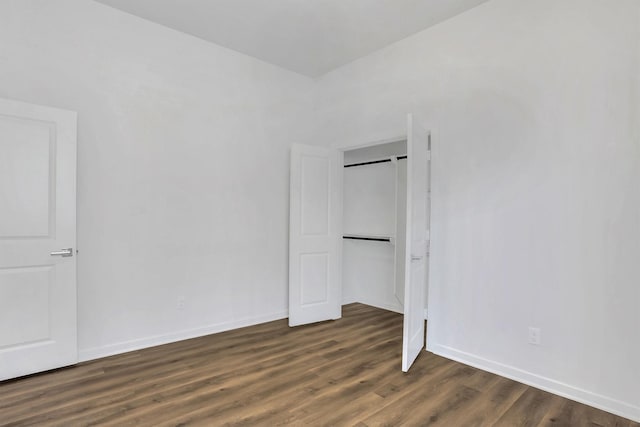 unfurnished bedroom featuring dark hardwood / wood-style floors