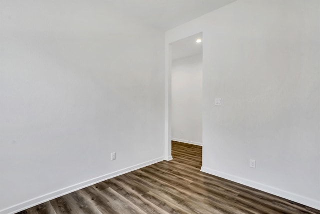 unfurnished room with dark hardwood / wood-style floors