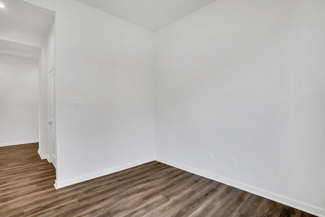 unfurnished room featuring dark hardwood / wood-style floors