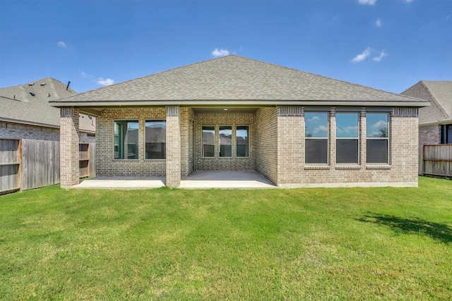 back of property featuring a yard and a patio