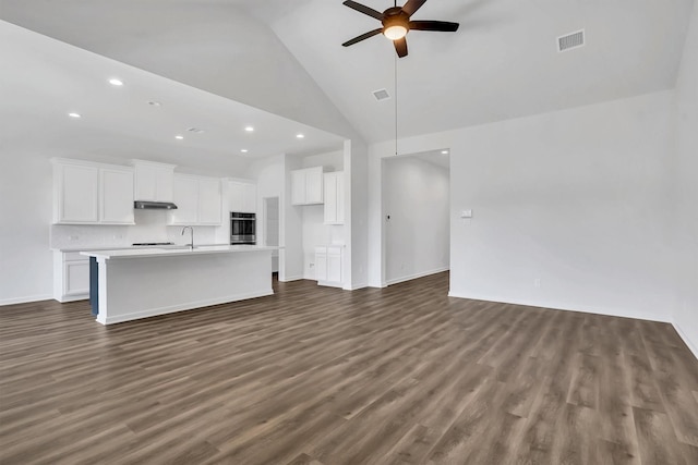 unfurnished living room featuring ceiling fan, dark hardwood / wood-style flooring, high vaulted ceiling, and sink