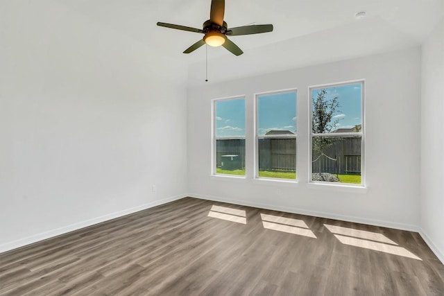 spare room featuring wood-type flooring and ceiling fan