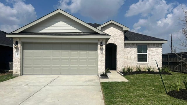 ranch-style house featuring a garage and a front lawn