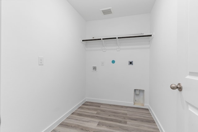 laundry room with hookup for an electric dryer, light hardwood / wood-style floors, gas dryer hookup, and hookup for a washing machine