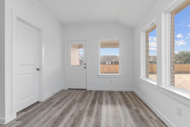 interior space featuring light hardwood / wood-style floors and lofted ceiling