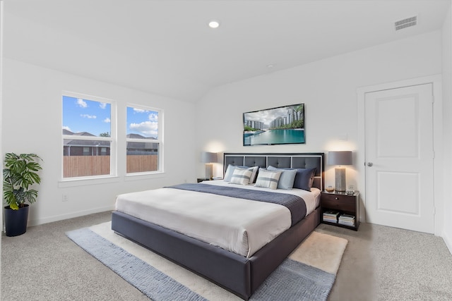 carpeted bedroom with lofted ceiling