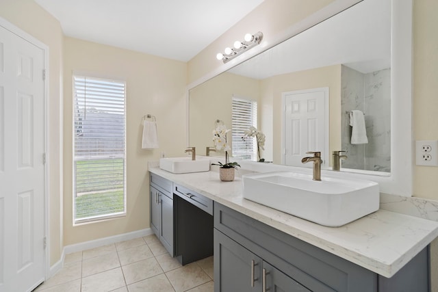 bathroom with tile patterned floors, plenty of natural light, and vanity