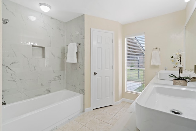 bathroom with tile patterned floors, sink, and tiled shower / bath