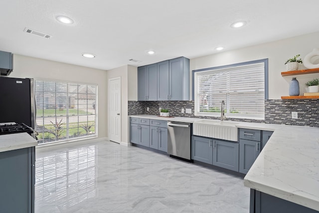 kitchen featuring a wealth of natural light, sink, appliances with stainless steel finishes, and tasteful backsplash