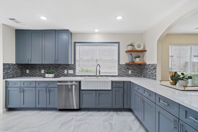 kitchen featuring tasteful backsplash, a healthy amount of sunlight, sink, and stainless steel dishwasher