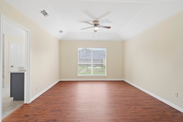 empty room featuring ceiling fan, wood-type flooring, and lofted ceiling