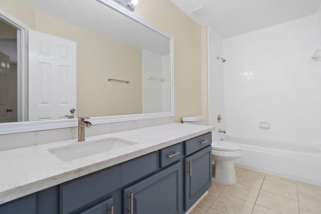 full bathroom with tile patterned floors, vanity, tiled shower / bath combo, and toilet