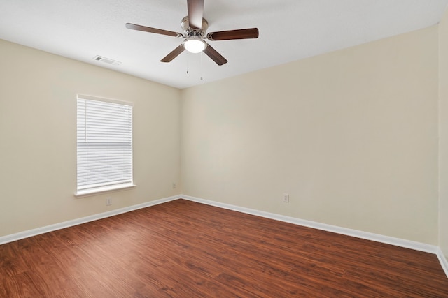 unfurnished room featuring ceiling fan and dark hardwood / wood-style flooring