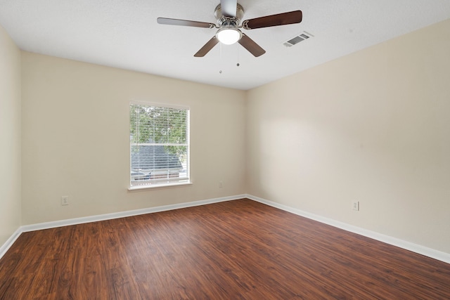 unfurnished room featuring ceiling fan and dark hardwood / wood-style flooring