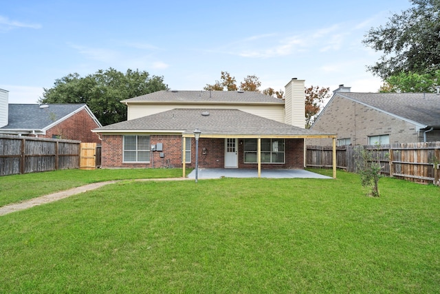 back of house with a yard and a patio