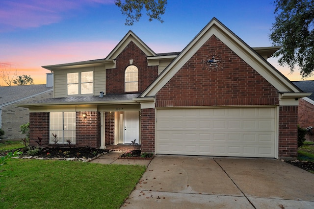 view of front property with a garage and a lawn