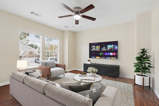 living room with ceiling fan and dark wood-type flooring