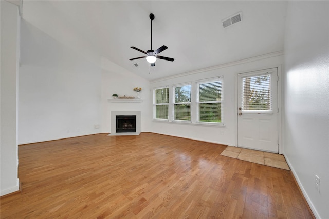 unfurnished living room with ceiling fan, light hardwood / wood-style floors, and vaulted ceiling