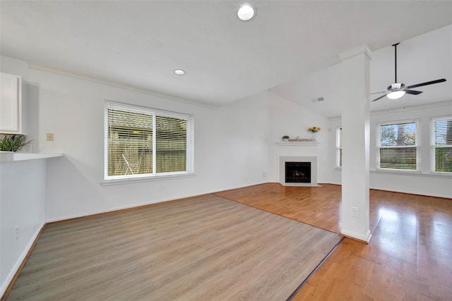 unfurnished living room featuring ceiling fan, crown molding, and light wood-type flooring