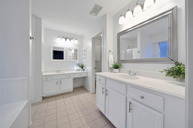 bathroom featuring tile patterned flooring, vanity, and walk in shower