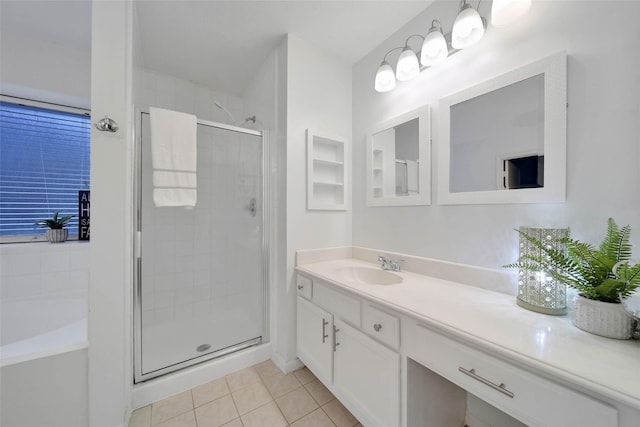 bathroom featuring tile patterned floors, vanity, and a shower with shower door