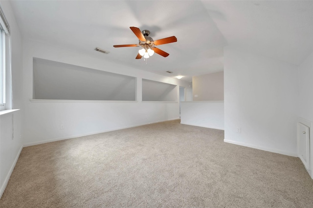 additional living space with ceiling fan and carpet floors