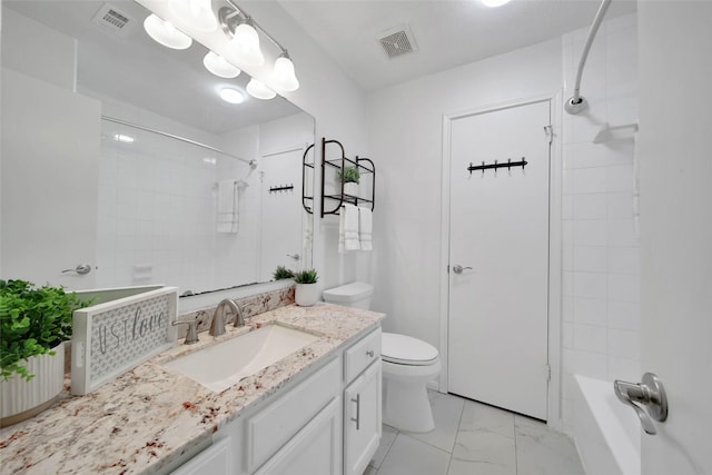 full bathroom with vanity, toilet, and tiled shower / bath