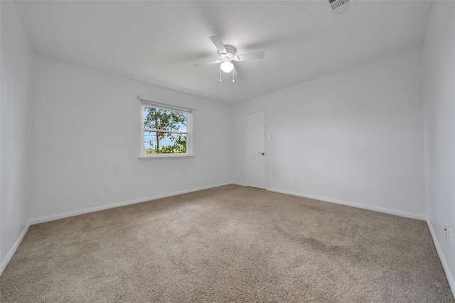 unfurnished room with ceiling fan and carpet