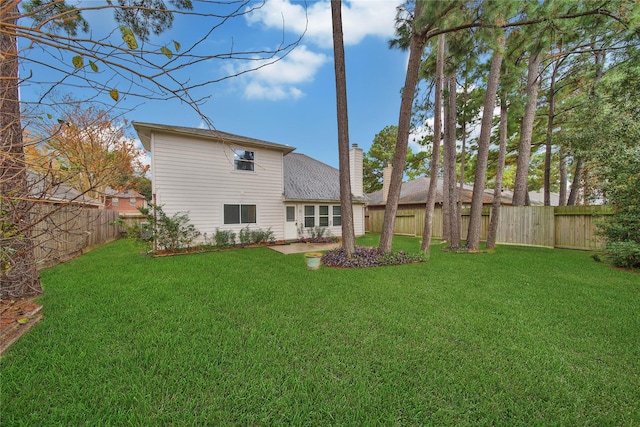 rear view of property with a lawn