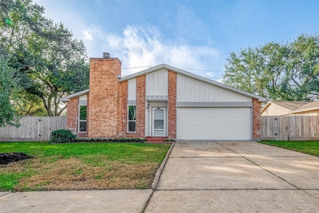 view of front of property featuring a garage and a front lawn