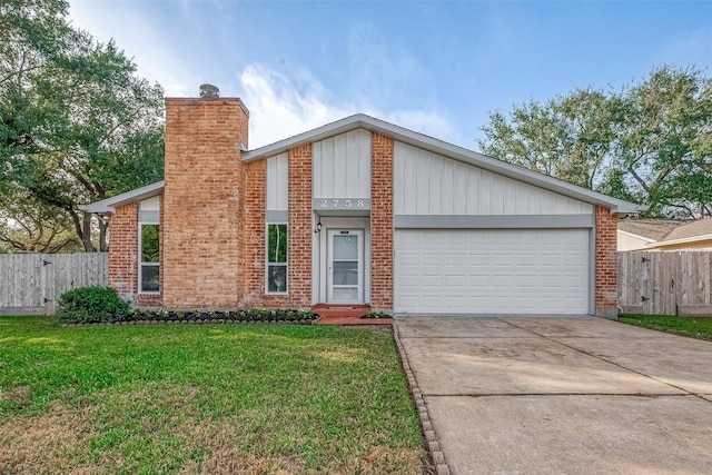 view of front of house featuring a garage and a front lawn