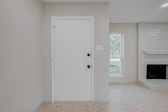 doorway to outside with a fireplace